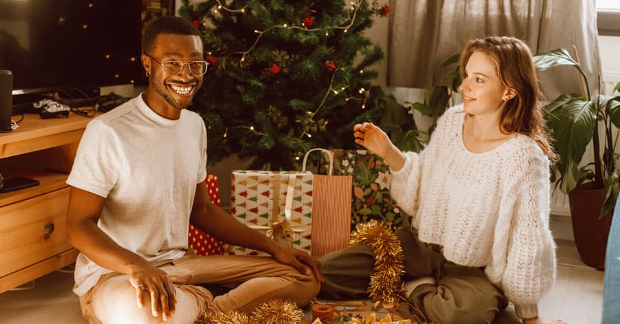 A couple wrapping gifts together.